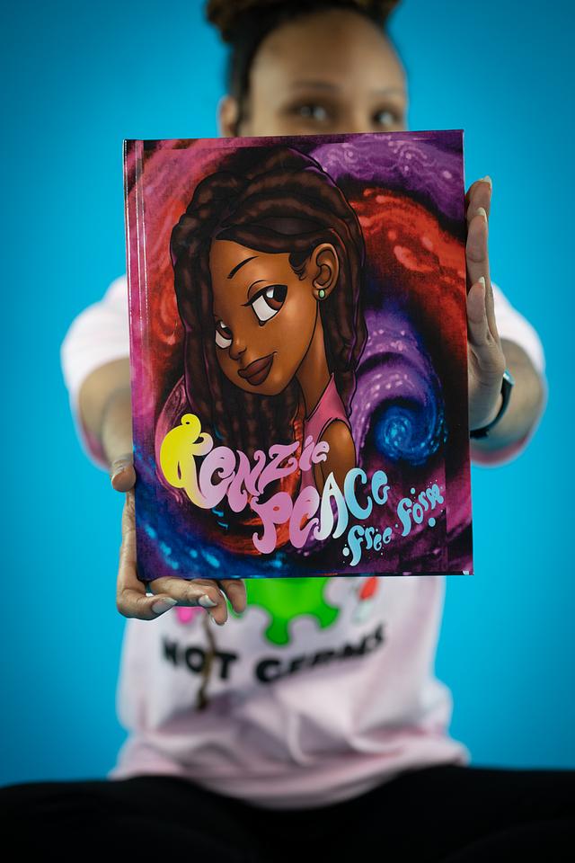 Tylar Phorever holding the Kenzie Peace children’s book
